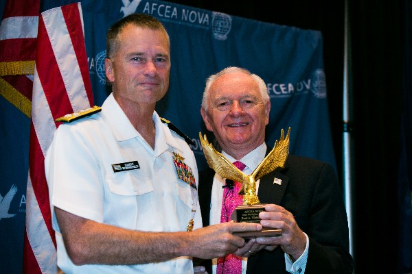 Adm. James Winnefeld Jr., USN (l), vice chairman of the Joint Chiefs of Staff, accepts a token of appreciation from Chuck Corjay, event lead for the 6th Annual Joint Warfighter IT Day in September.